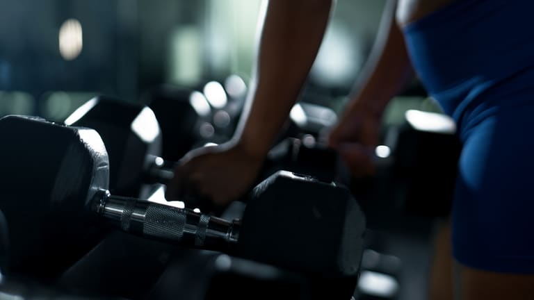 A member choosing dumbbells